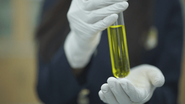 Student holding a test tube with liquid