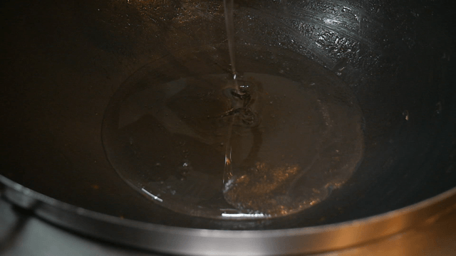 Honey being poured into a heated pan
