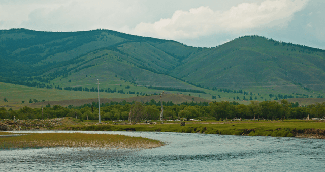 A serene river flowing through green hills