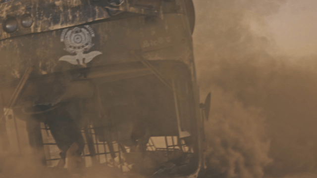 Overturned bus in a dusty environment