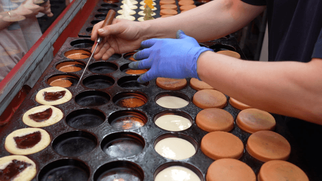 Red bean cakes being golden brown on the griddle