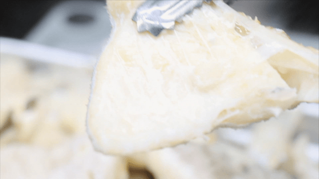 Tongs lifting boiled cod