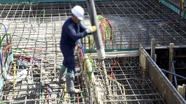 Construction worker pouring concrete