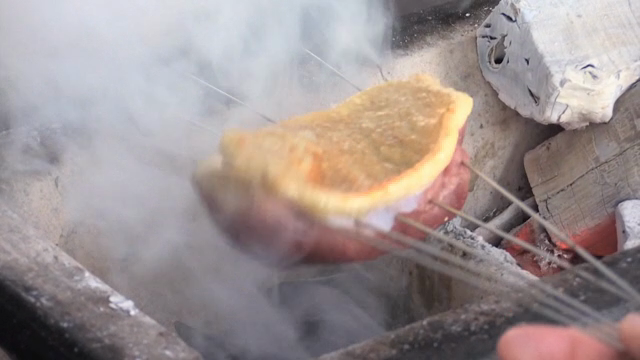 Duck meat grilled over charcoal with smoke