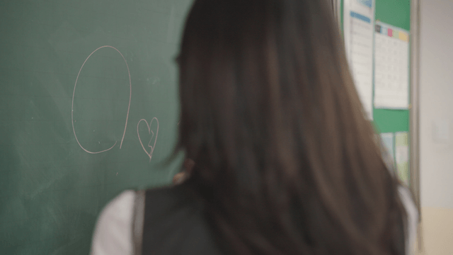 Students teasing and doodling on the chalkboard