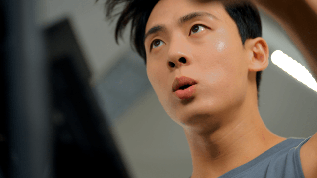 Young man intensely working out at gym