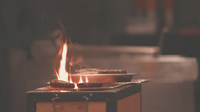 Strong charcoal fire grilling ingredients on the grill