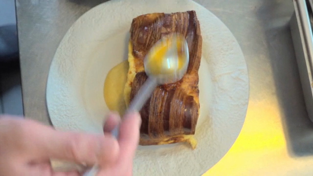 A dish being prepared with sauce