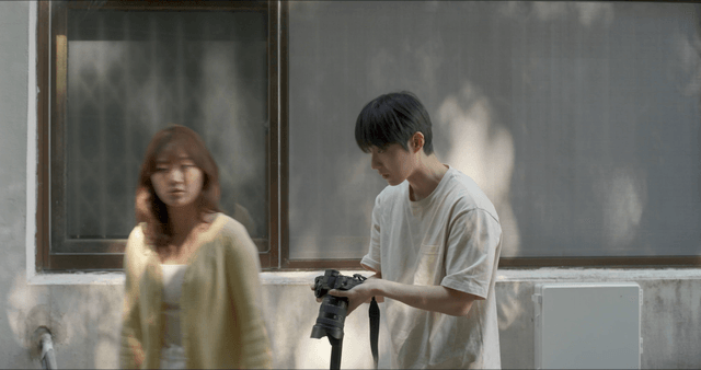 Woman leaving after talking with man about photo taken by camera
