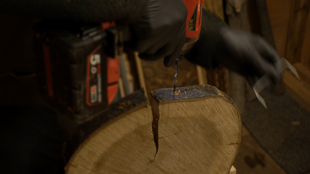 Woodcraft artisan drilling wood in workshop