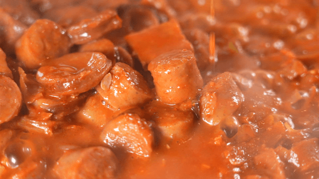 Rich broth poured into budaejjigae  