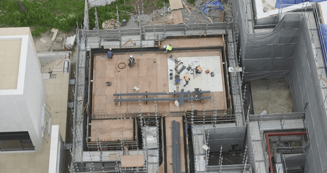Construction site in front of a park