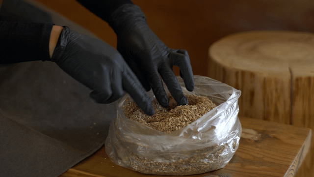 Woodcraft artisan organizing sawdust packed in plastic bags