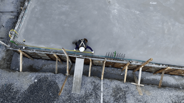 Worker measuring concrete surface