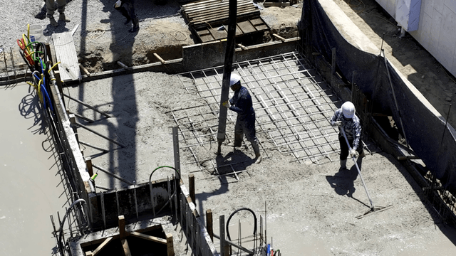 Construction workers pouring concrete