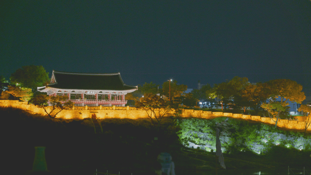 Traditional Korean pavilion illuminated at night