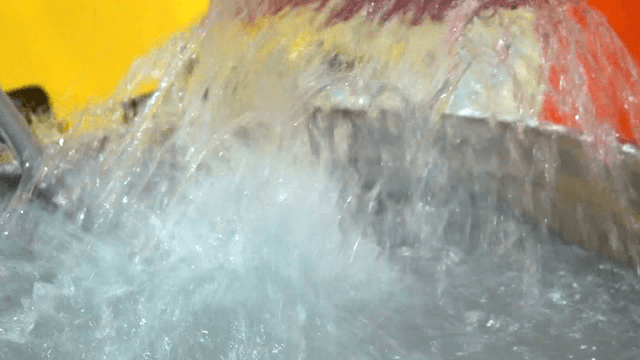 Ice fish being vigorously washed in red basket