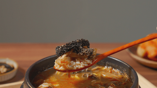 Spoonful of beef tripe soup with rice