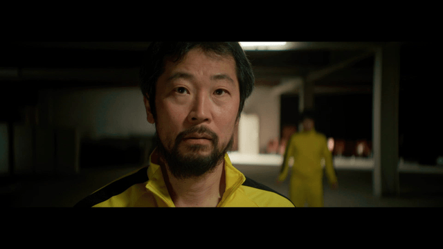 Man in a yellow tracksuit indoors